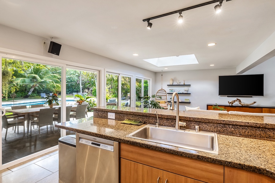 The kitchen sink overlooks the living area and lanai