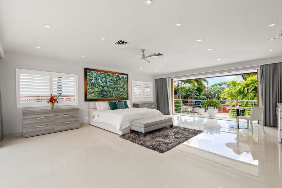 Your spacious master suite opens to lush tropical gardens, blending modern elegance with calming natural light and serene outdoor views—your private sanctuary awaits.