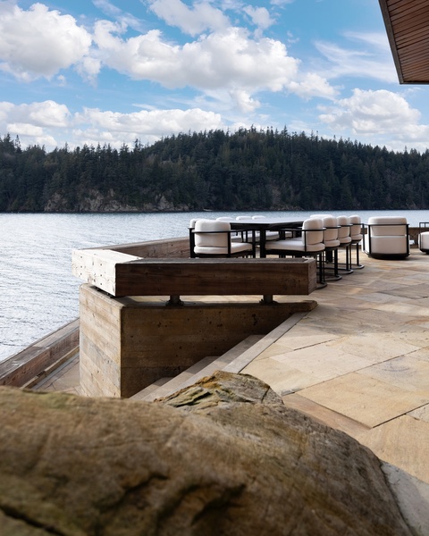 Waterfront terrace overlooking forested hills and peaceful lake waters.