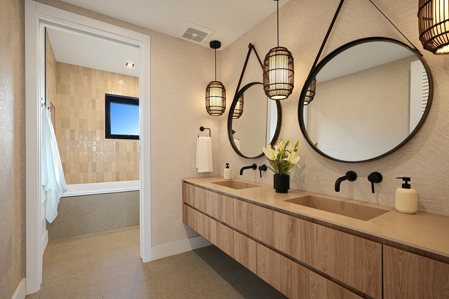 Guest bath with double vanity and pendant lighting.