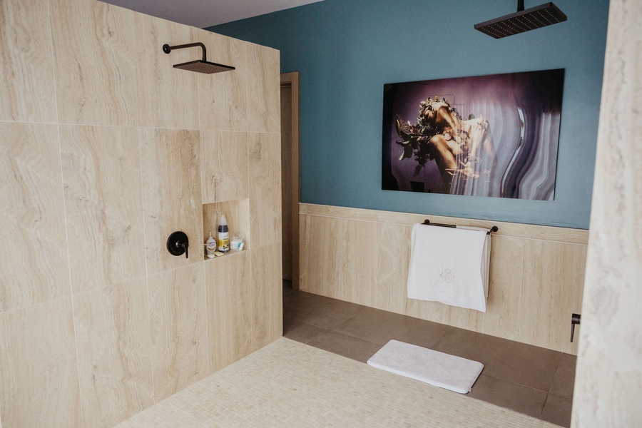 The primary ensuite bath features a unique art piece.