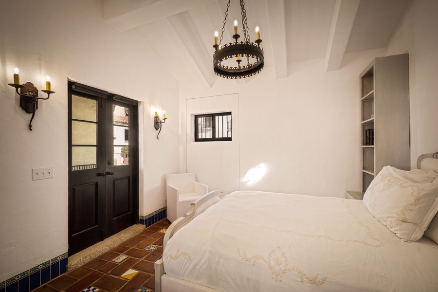 Unwind in your elegant bedroom where rustic charm meets modern comfort, featuring crisp linens and warm candlelit ambiance.