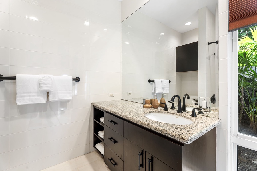 Refresh in your elegant bathroom featuring granite countertops, modern fixtures, and a luxurious soaking tub—your perfect retreat.