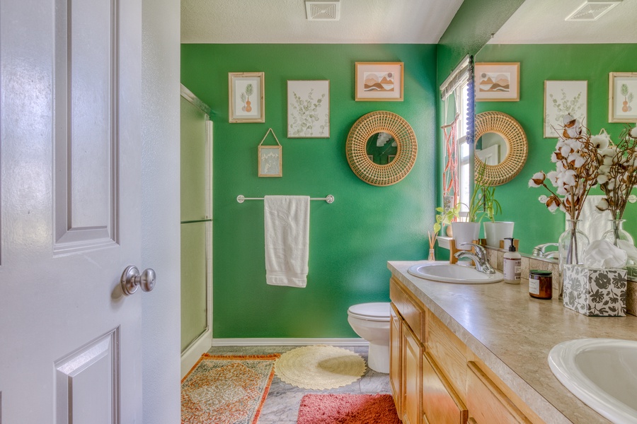 The ensuite bath is bright and lively