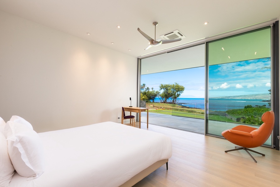 Wake up to breathtaking ocean views in this minimalist primary suite.