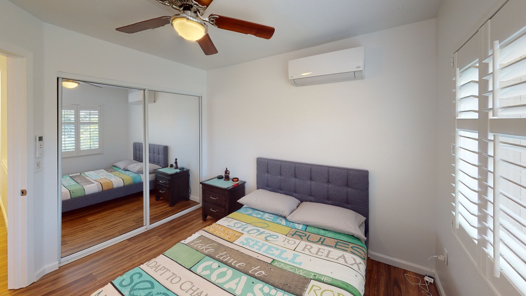 The third guest bedroom features storage and a ceiling fan.
