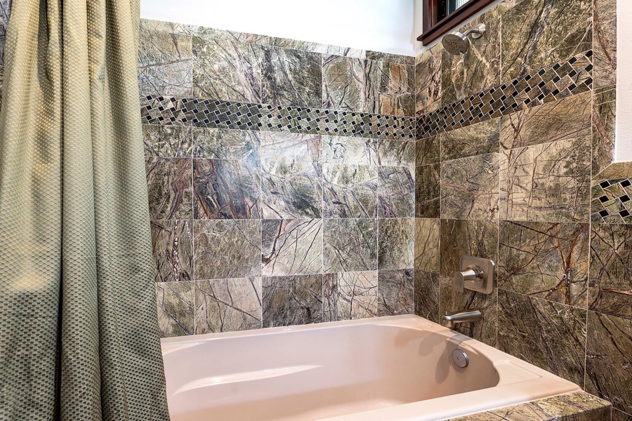 Guest bedroom featuring tub/shower combo