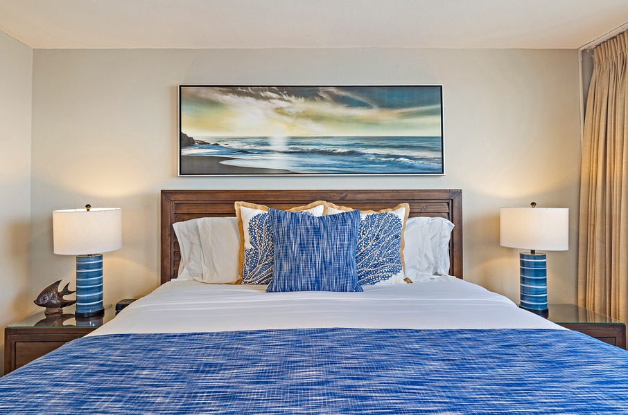 The bedroom offers a cozy king-sized bed with soft, ocean-inspired accents, creating a relaxing retreat.