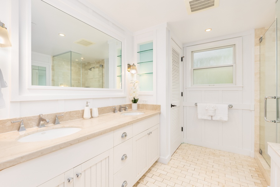 Your spacious ensuite offers dual vanities and a luxurious glass-enclosed shower for refreshing mornings.