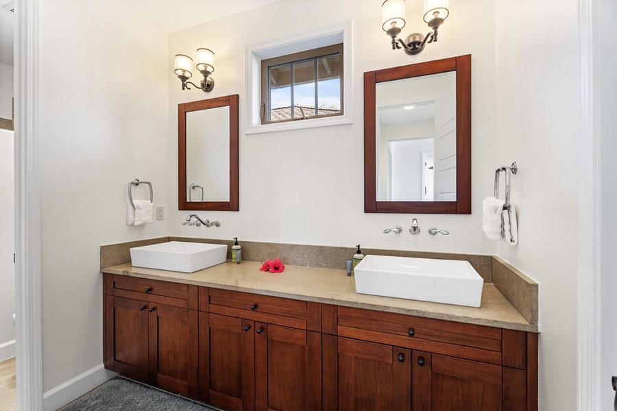 Spacious guest bathroom with dual vanities for added convenience.