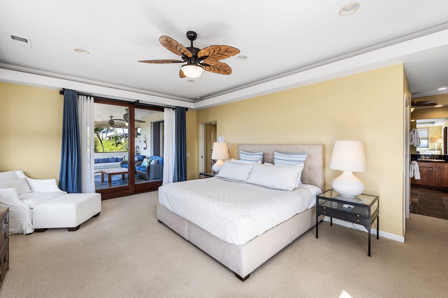 Elegant primary suite with a king-sized bed, private balcony access, and tranquil garden views.