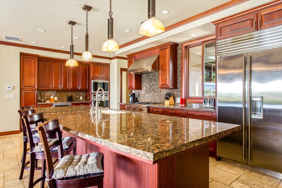 Perfect for morning coffee or casual meals, the kitchen island offers bar seating under elegant pendant lights.