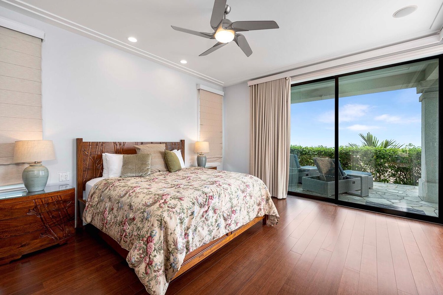 The primary bedroom with King sized bed, attached ensuite, and phenomenal views!