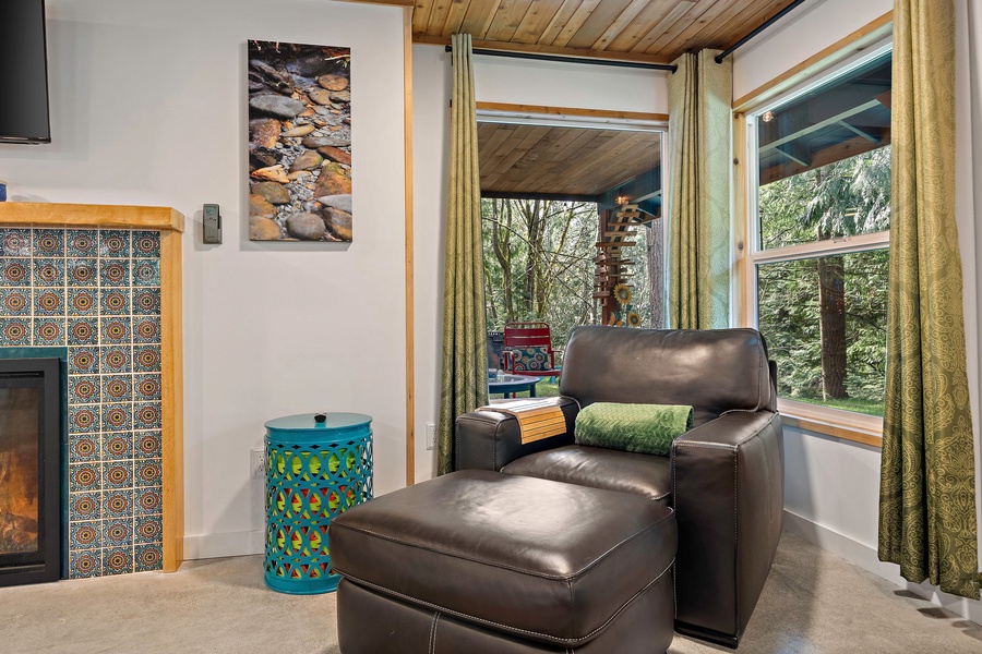 A cozy corner chair offers a quiet retreat to read, relax, or enjoy the tranquil views just beyond the windows.
