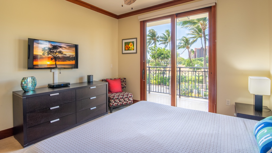 The primary guest bedroom with lanai access and TV.