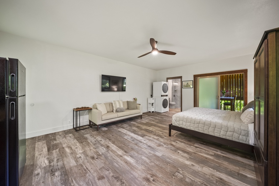 Studio lounge area with smart TV, mini kitchenette, and washer/dryer—perfect for long stays.