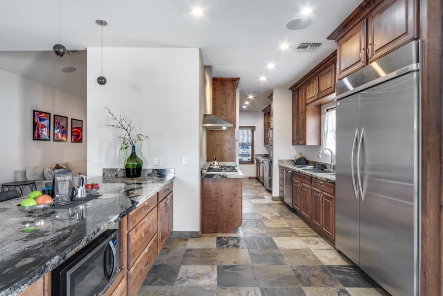 Fully equipped chef's kitchen features a wine refrigerator and butler's pantry for extra storage