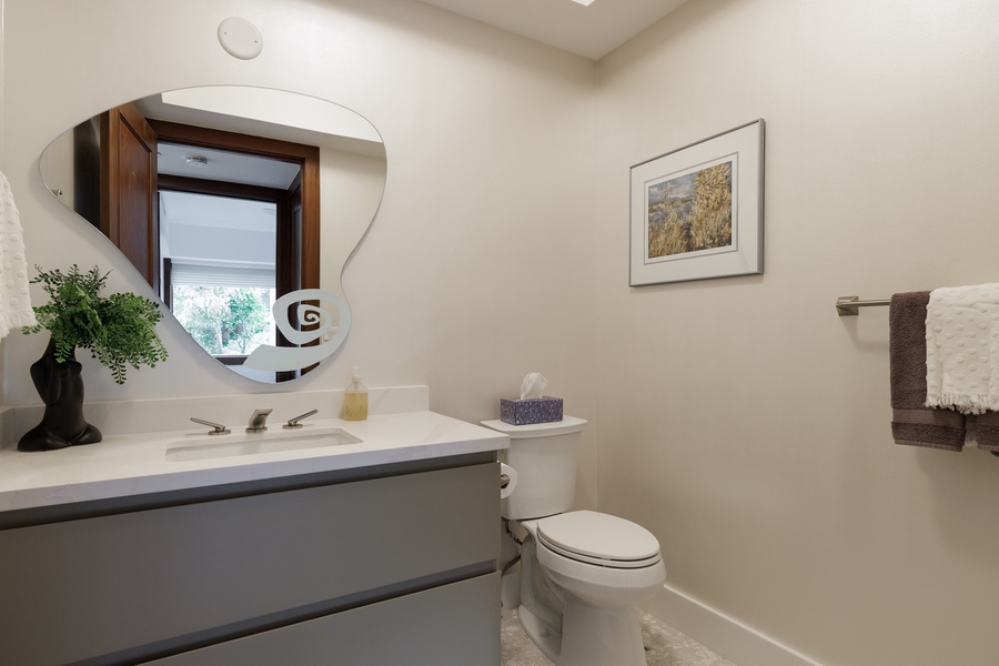 A convenient half bath with a single sink, perfect for guest use.