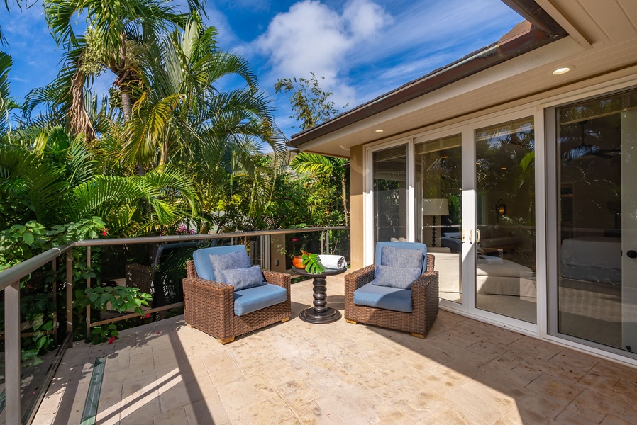 Step onto your private tropical lanai where wicker chairs await among swaying palms and vibrant gardens.