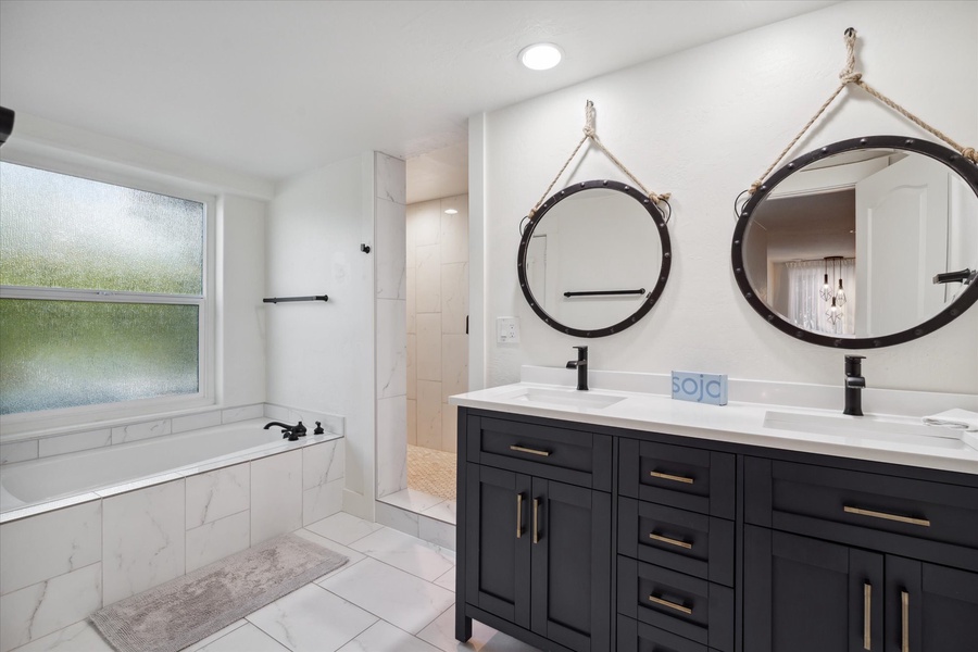 Ensuite bathroom with dual sink and a walk-in shower/tub and closet.
