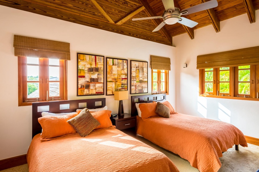 Guest bedroom with twin beds and vibrant decors.