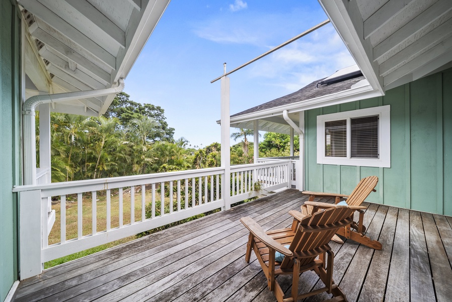 Private upper-level lanai with comfortable seating—ideal for morning coffee, afternoon reading, or simply soaking in the tropical views and gentle breezes.