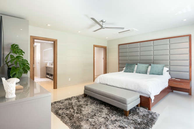 Bright guest bedroom with asian king bed, ensuite bath, and a calming coastal palette.