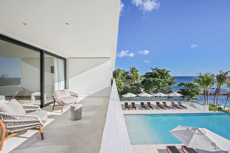 Enjoy the view from the balcony overlooking the pool and ocean.