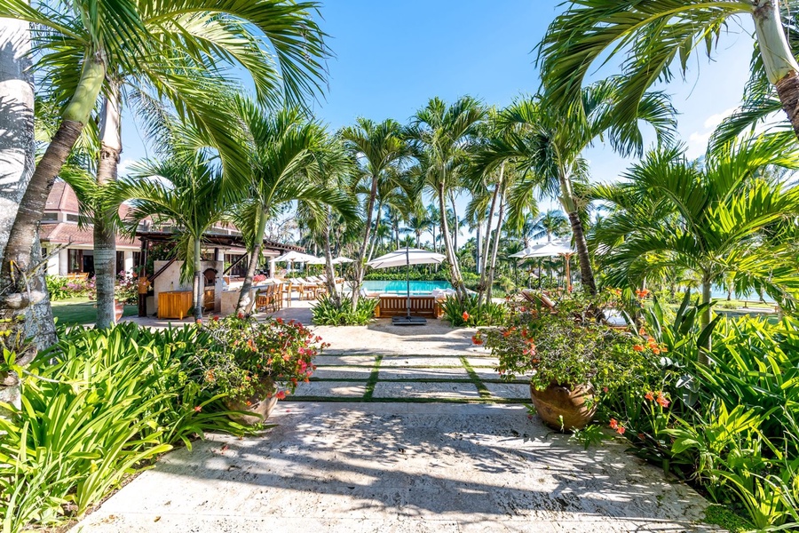 Lush tropical garden pathway leading to the pool area.