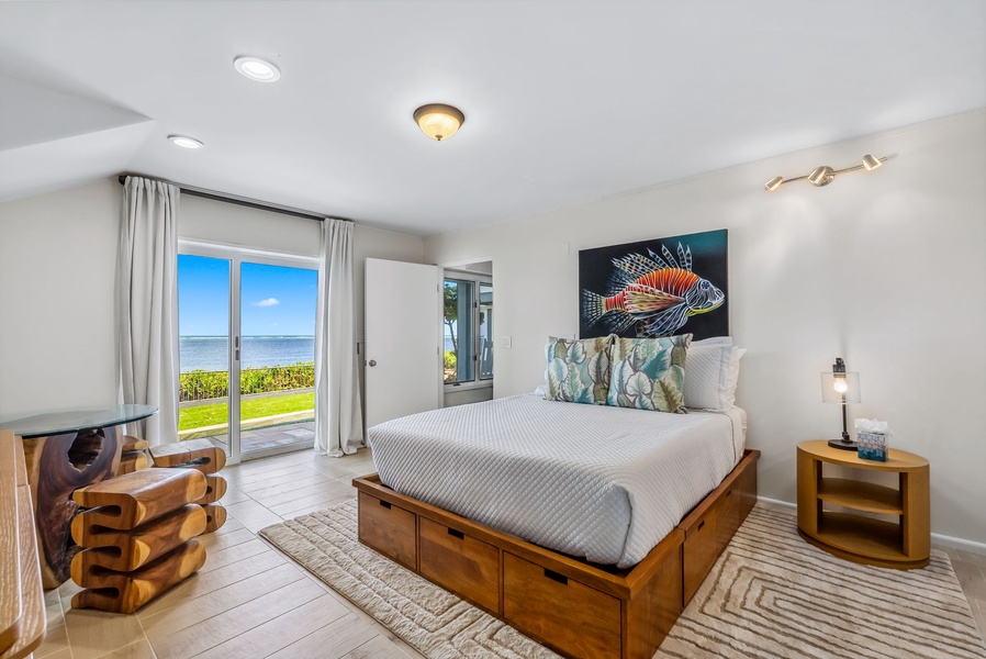Second guest suite with ocean view, soft tones, and a queen bed for a peaceful island retreat.