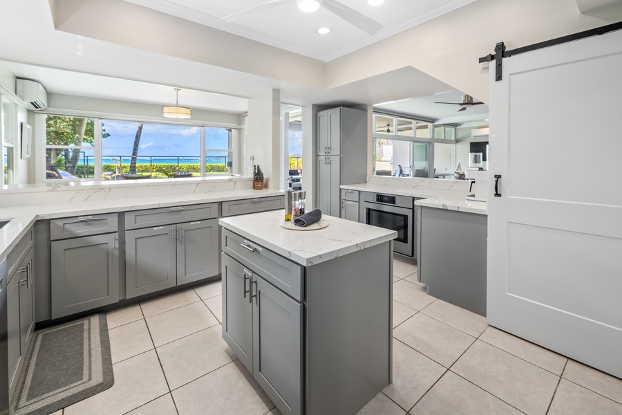 Conveniently prepare meals on the fully equipped kitchen with ocean views and plenty of counter space.