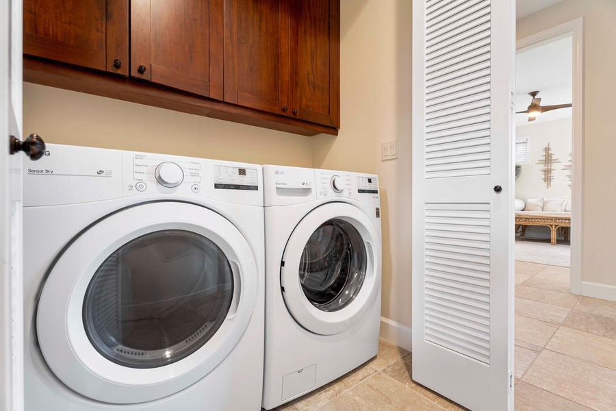 Efficient and compact laundry room equipped with modern appliances and ample storage.