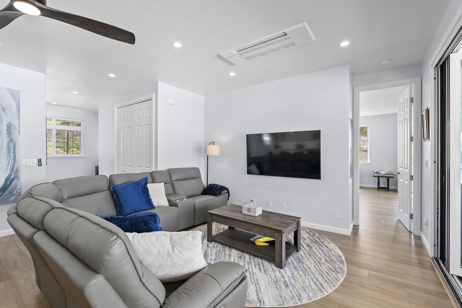 The upstair living area features plush sectional seating and a smart TV.