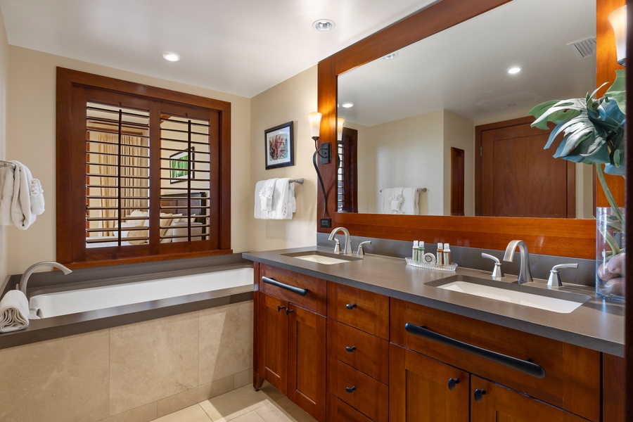 The primary guest bathroom with a walk-in shower and soaking tub.