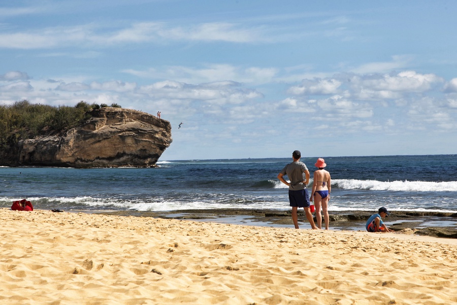 Stroll along the rugged Shipwreck Beach with golden sands and dramatic cliffs, perfect for adventure and photography.