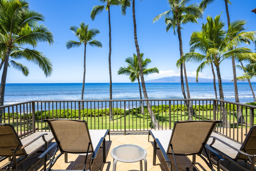 Relax on the private lanai with breathtaking oceanfront views and swaying palm trees.