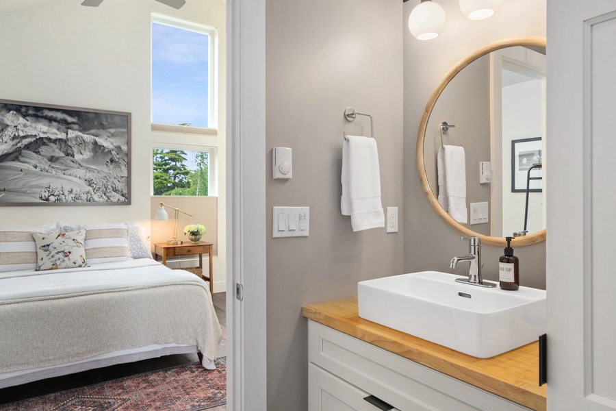 The ensuite connects to the bedroom and is bright, simple, and stylish.