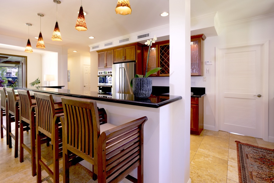 Breakfast bar with seating for five connects the living and kitchen space