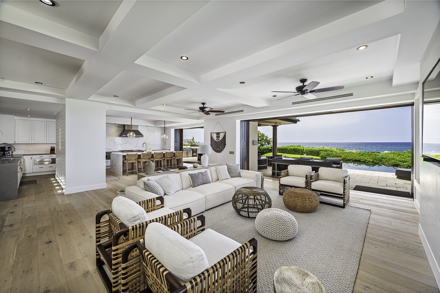 Open concept living room with built in 80 inch TV, Restoration Hardware furniture from their Luxury Beach Edition