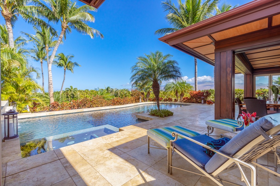 Soak up the sun from your private loungers beside the sparkling pool and lush landscaping.