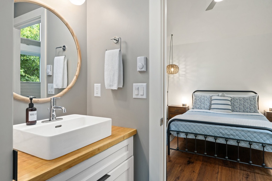 Crisp and clean with a modern vanity and circular mirror for easy mornings.
