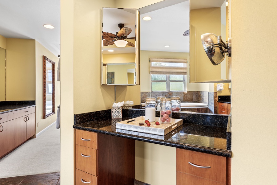 Modern bathroom vanity with granite countertops and bright lighting for a refreshing start to your day.