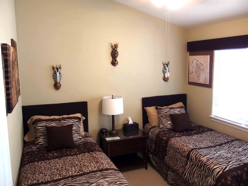 The third bedroom is comfortably furnished with two twin beds, an overhead fan, and a  32-inch Smart T.V. All televisions feature cable, including Netflix, for your enjoyment.