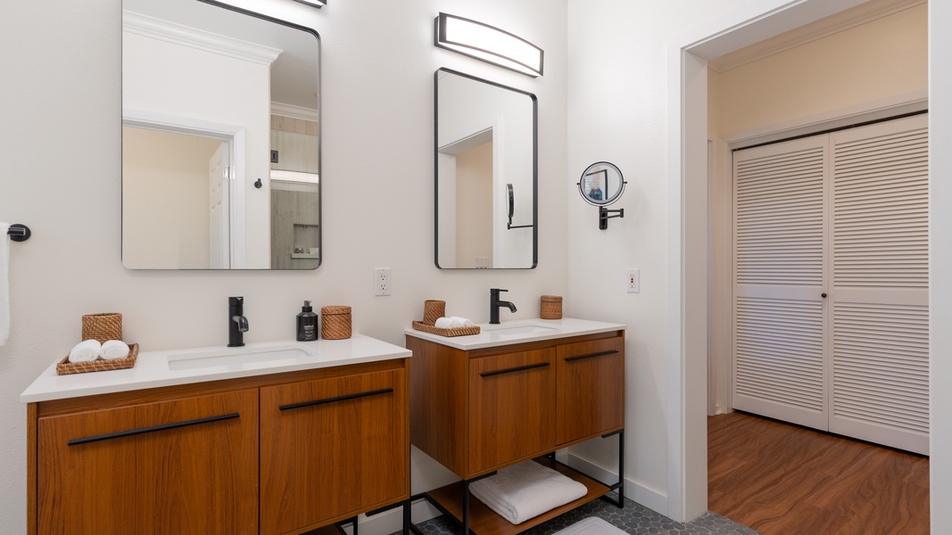The primary guest bathroom with ample lighting and dual vanities.