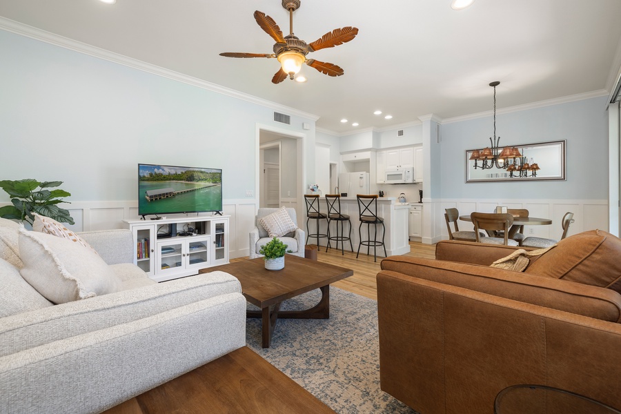 Cozy up in the thoughtfully furnished living room with flatscreen TV and soothing island décor.