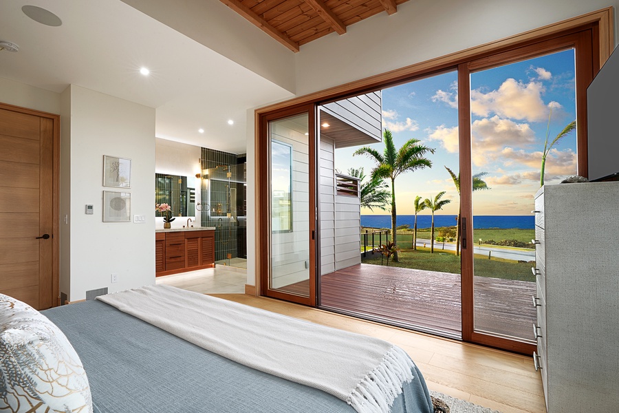 The third guest suite with TV, ensuite bath, floor-to-ceiling windows and access to private lanai..