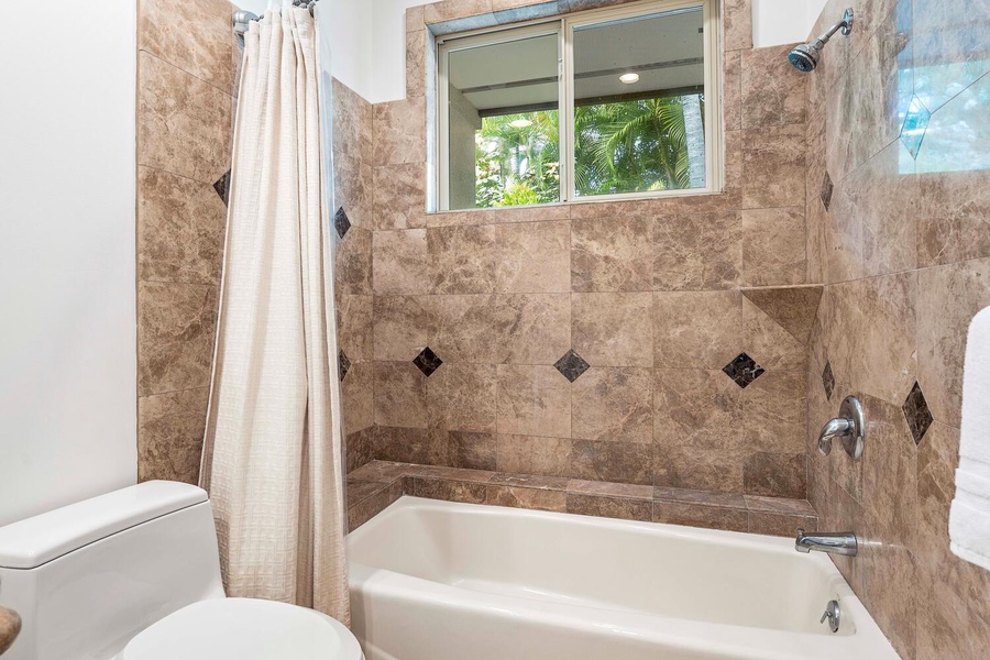 The ensuite bathroom with a shower/tub combo.