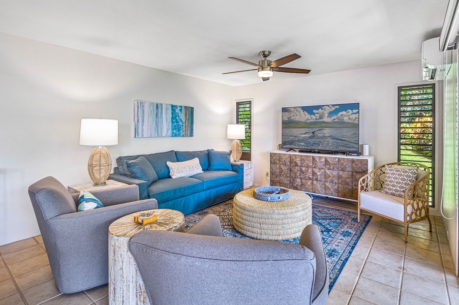 The cozy living room features comfortable seating and a large TV, perfect for relaxing after a day of exploring.