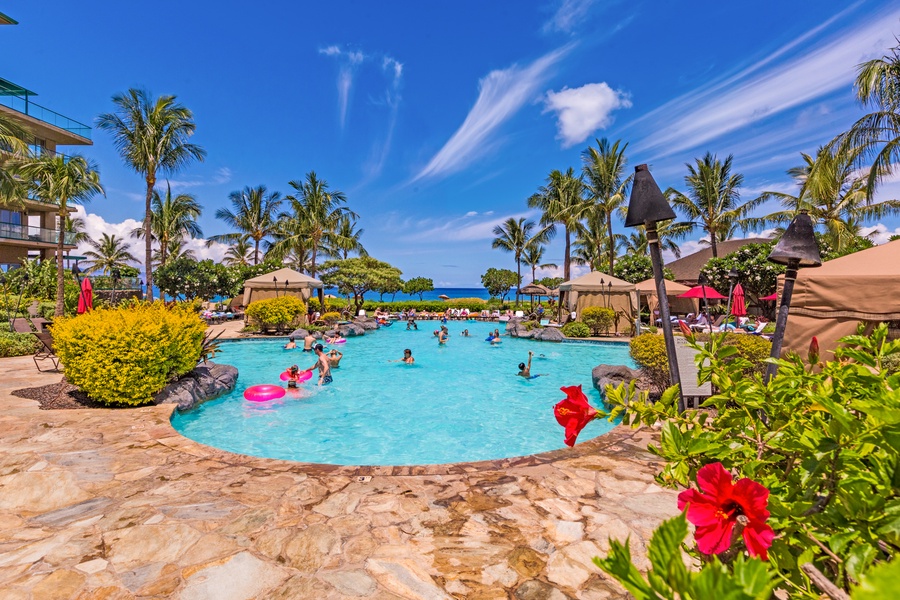 Full access to family-friendly pools surrounded by palm trees and colorful blooms