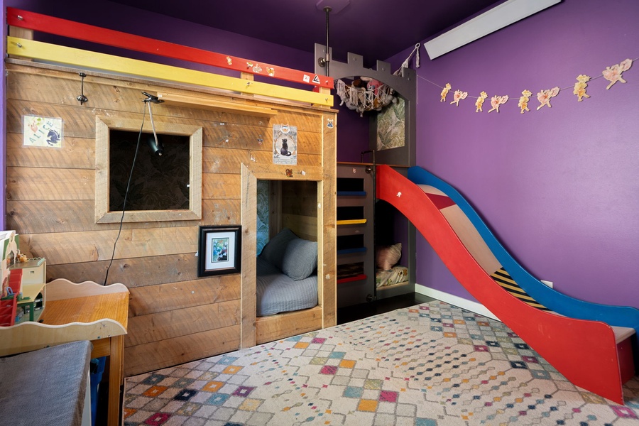 Your little adventurers will love this themed bedroom with its wooden fort bunk bed and fun slide for endless play and cozy sleep.